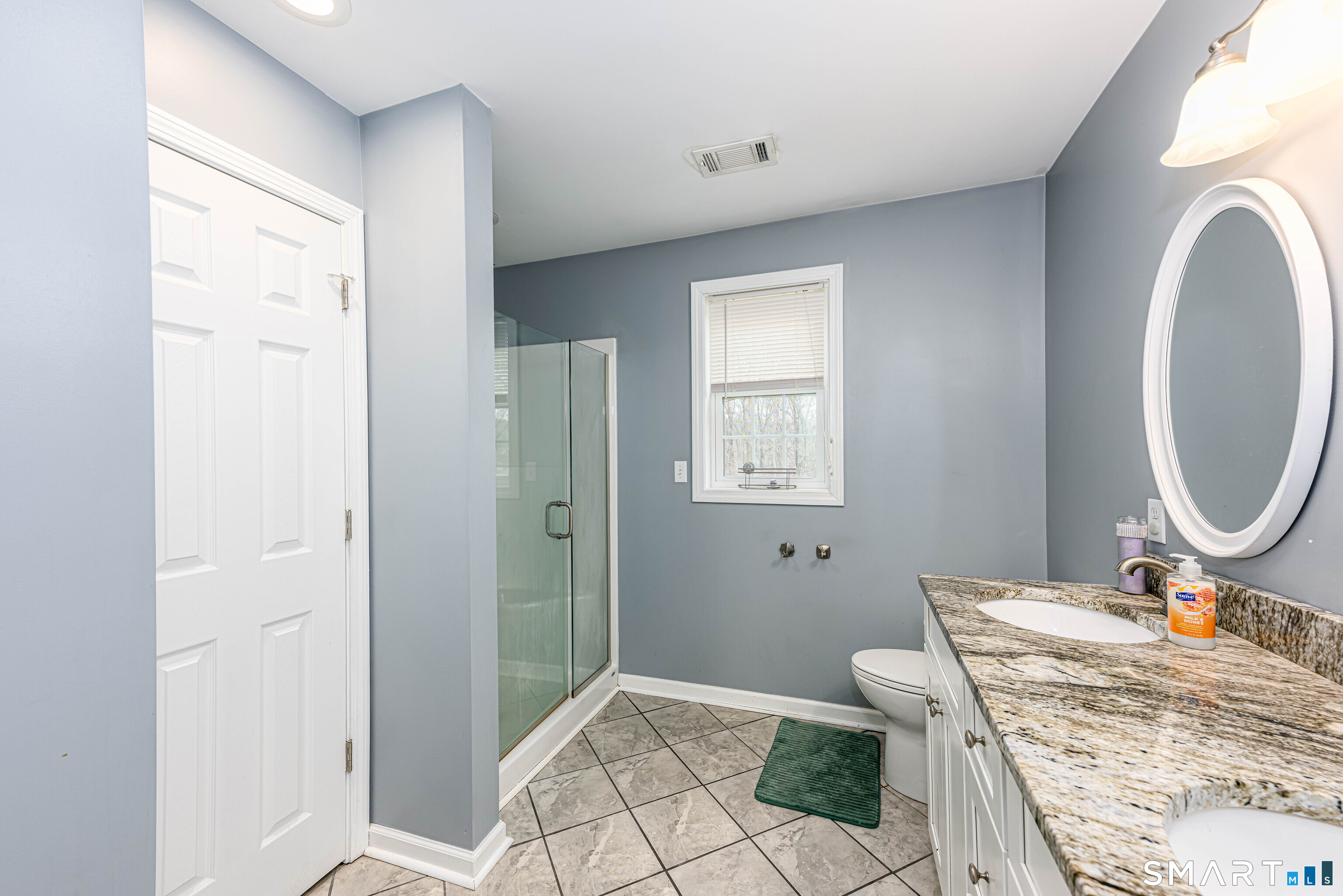 112 Orchard Street Meriden, CT 06450 - Photo 17 of 30 a bathroom with a granite countertop sink a mirror and a toilet