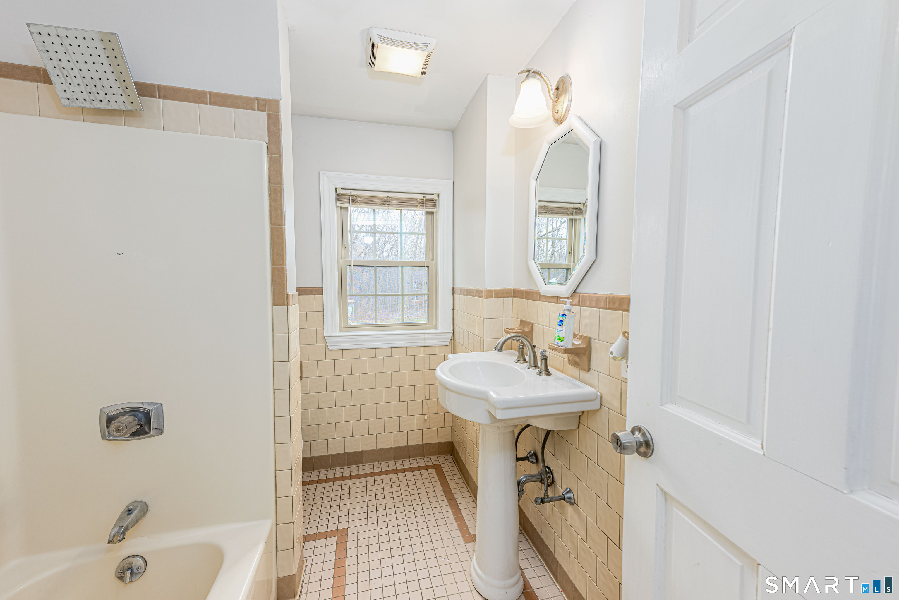 112 Orchard Street Meriden, CT 06450 - Photo 19 of 30 a bathroom with a sink mirror and tub