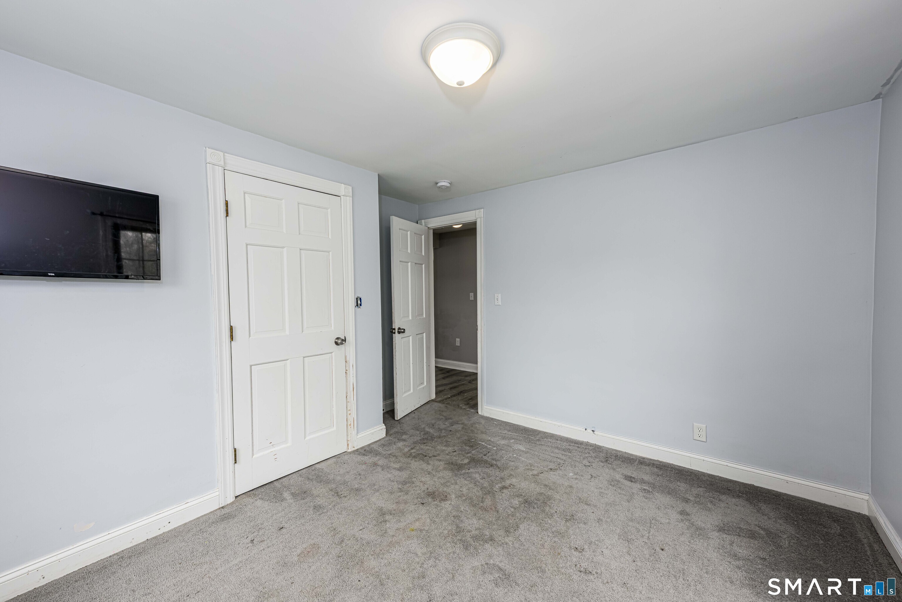 112 Orchard Street Meriden, CT 06450 - Photo 23 of 30 a view of an empty room with a flat screen tv