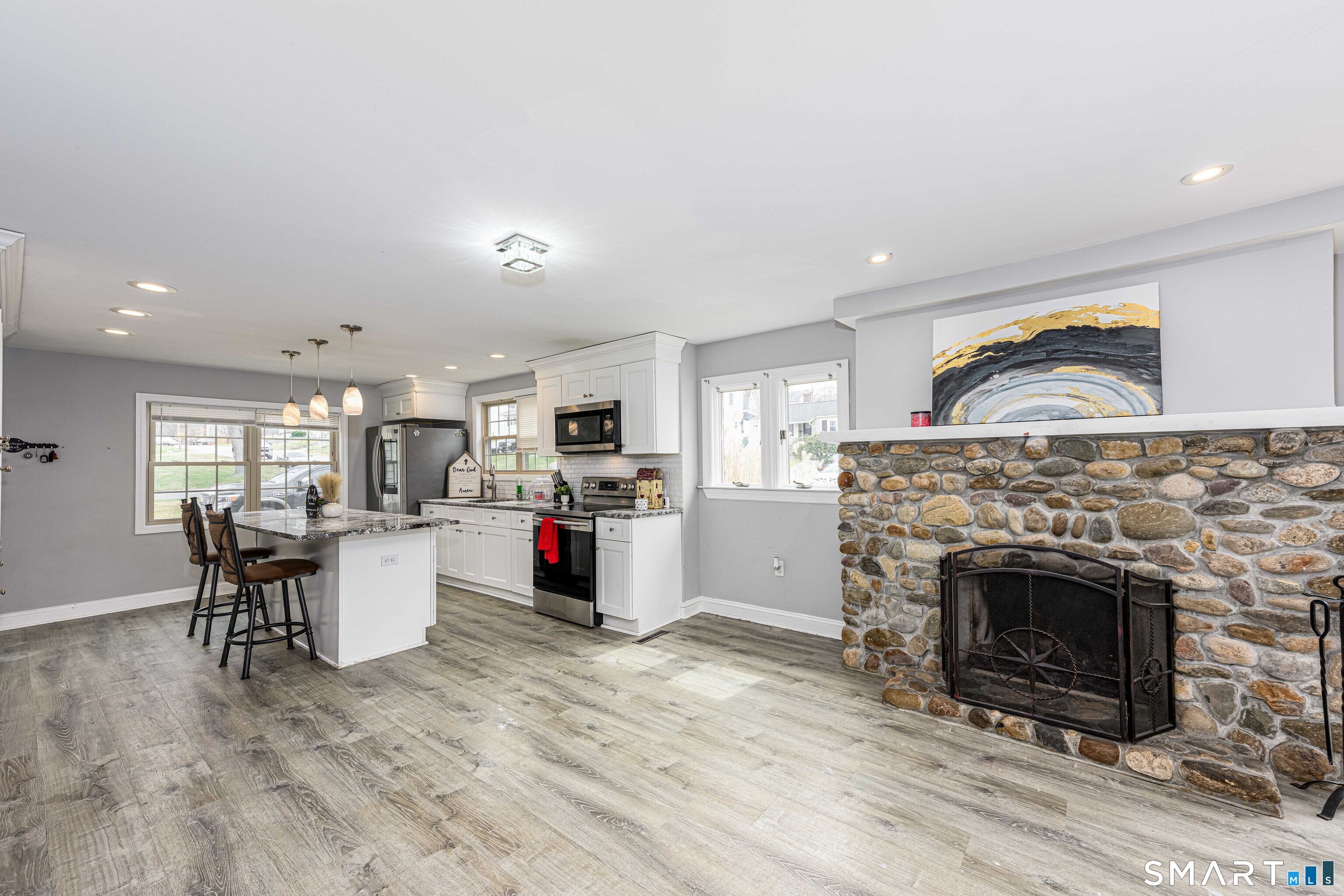 112 Orchard Street Meriden, CT 06450 - Photo 7 of 30 a living room with furniture a fireplace and kitchen view