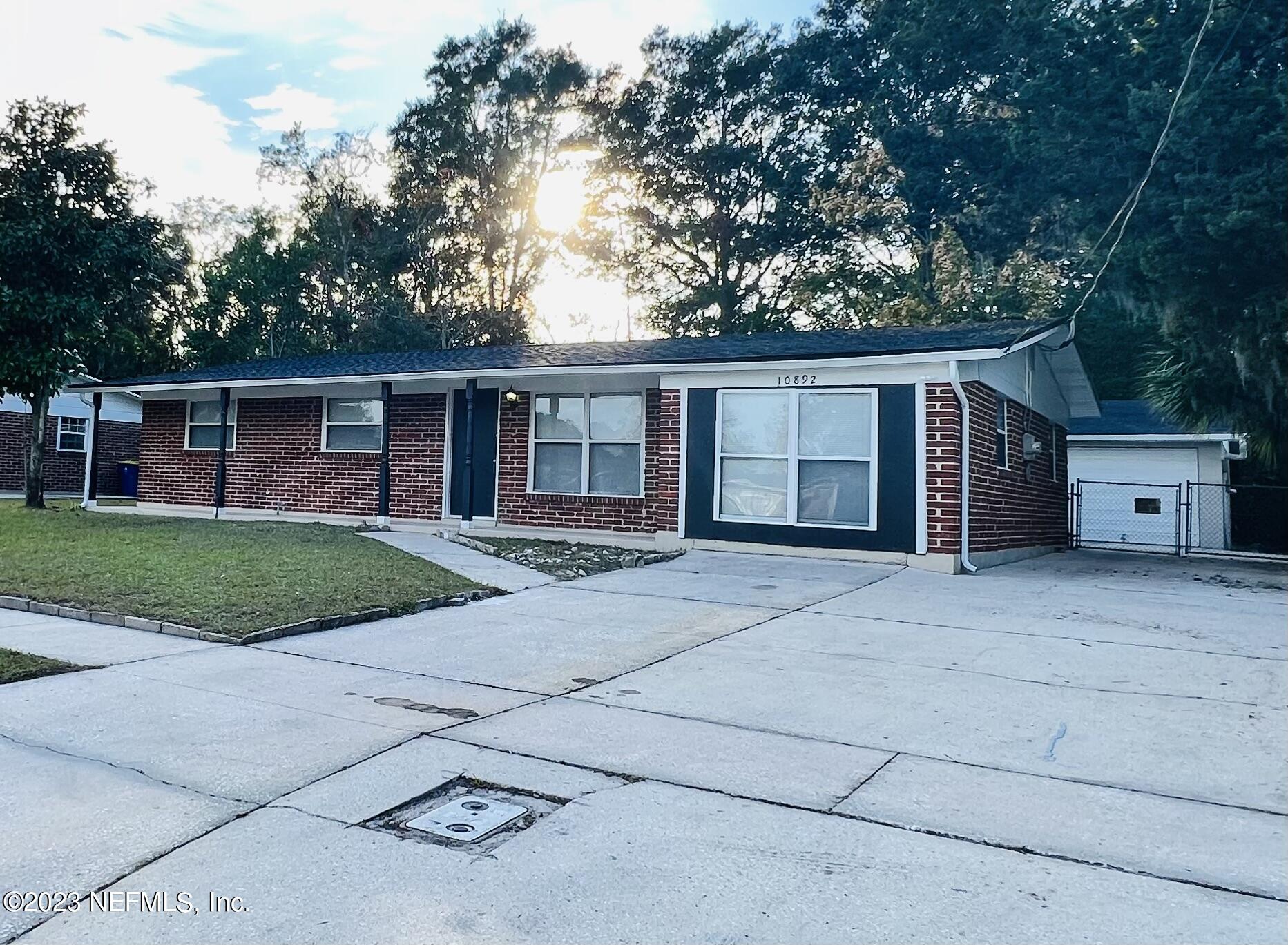 10892 Player Road Jacksonville, FL 32218 - Photo 1 of 37 a front view of house with yard and trees in the background