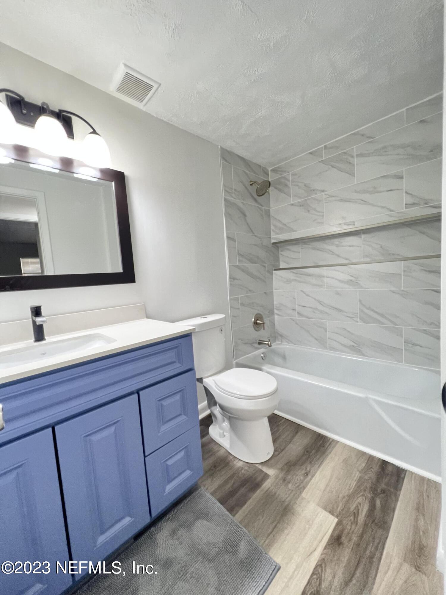 10892 Player Road Jacksonville, FL 32218 - Photo 20 of 37 a bathroom with a toilet sink and mirror