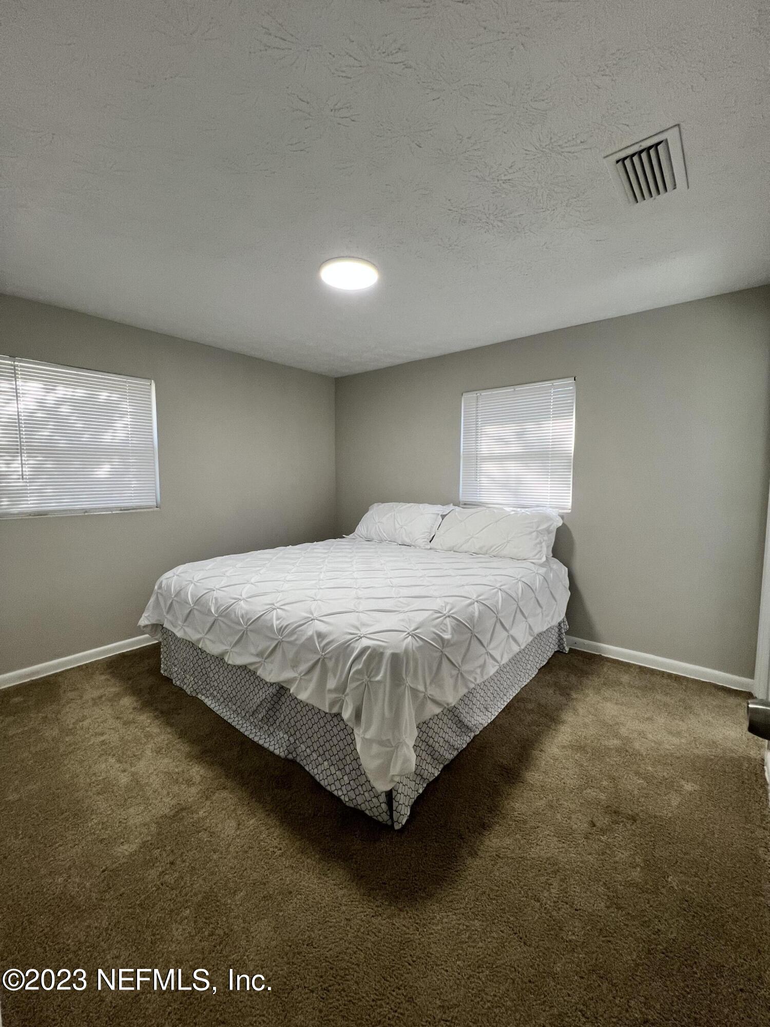10892 Player Road Jacksonville, FL 32218 - Photo 25 of 37 a bedroom with a bed and a window