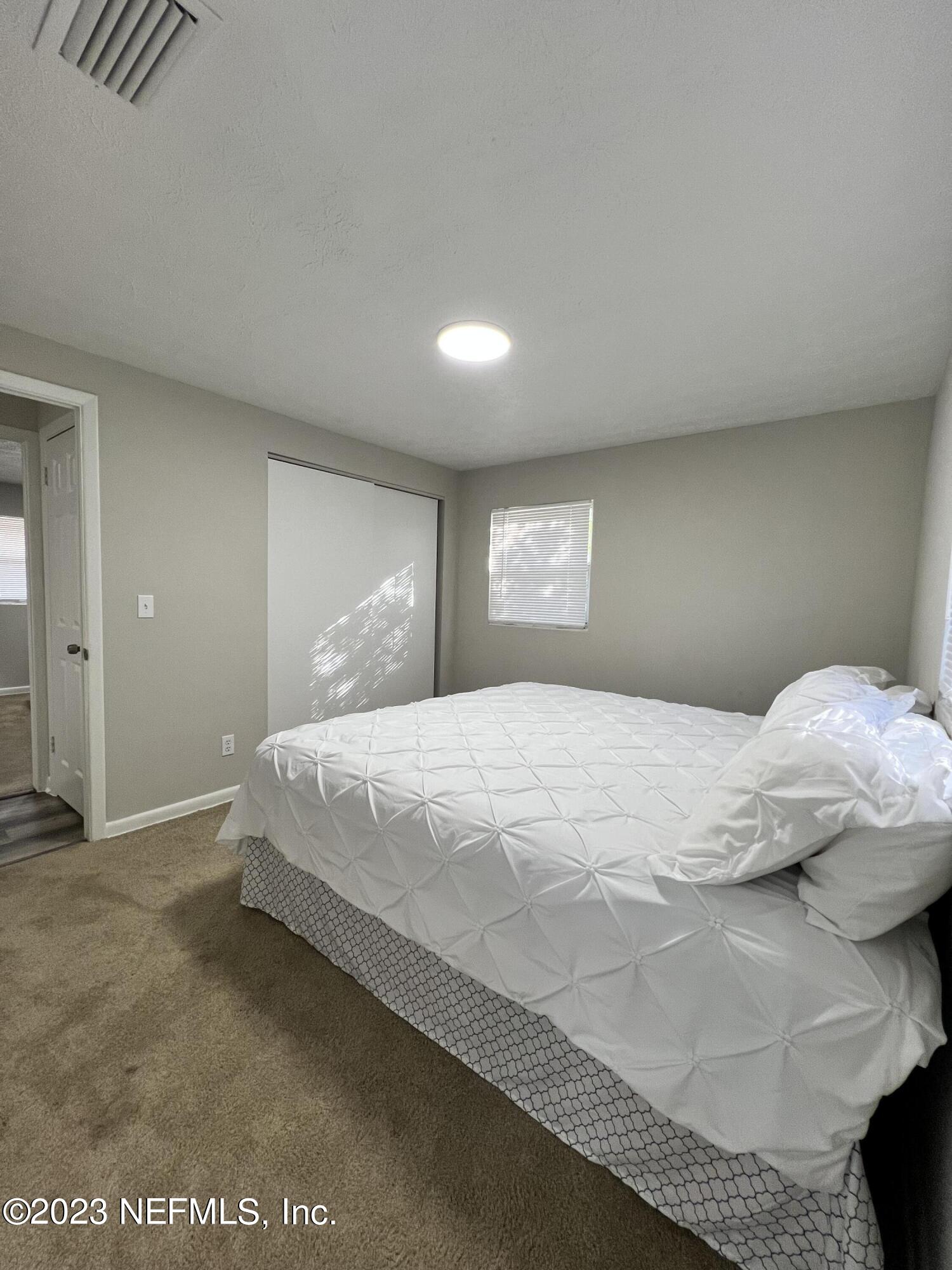 10892 Player Road Jacksonville, FL 32218 - Photo 26 of 37 a bedroom with a bed and a window