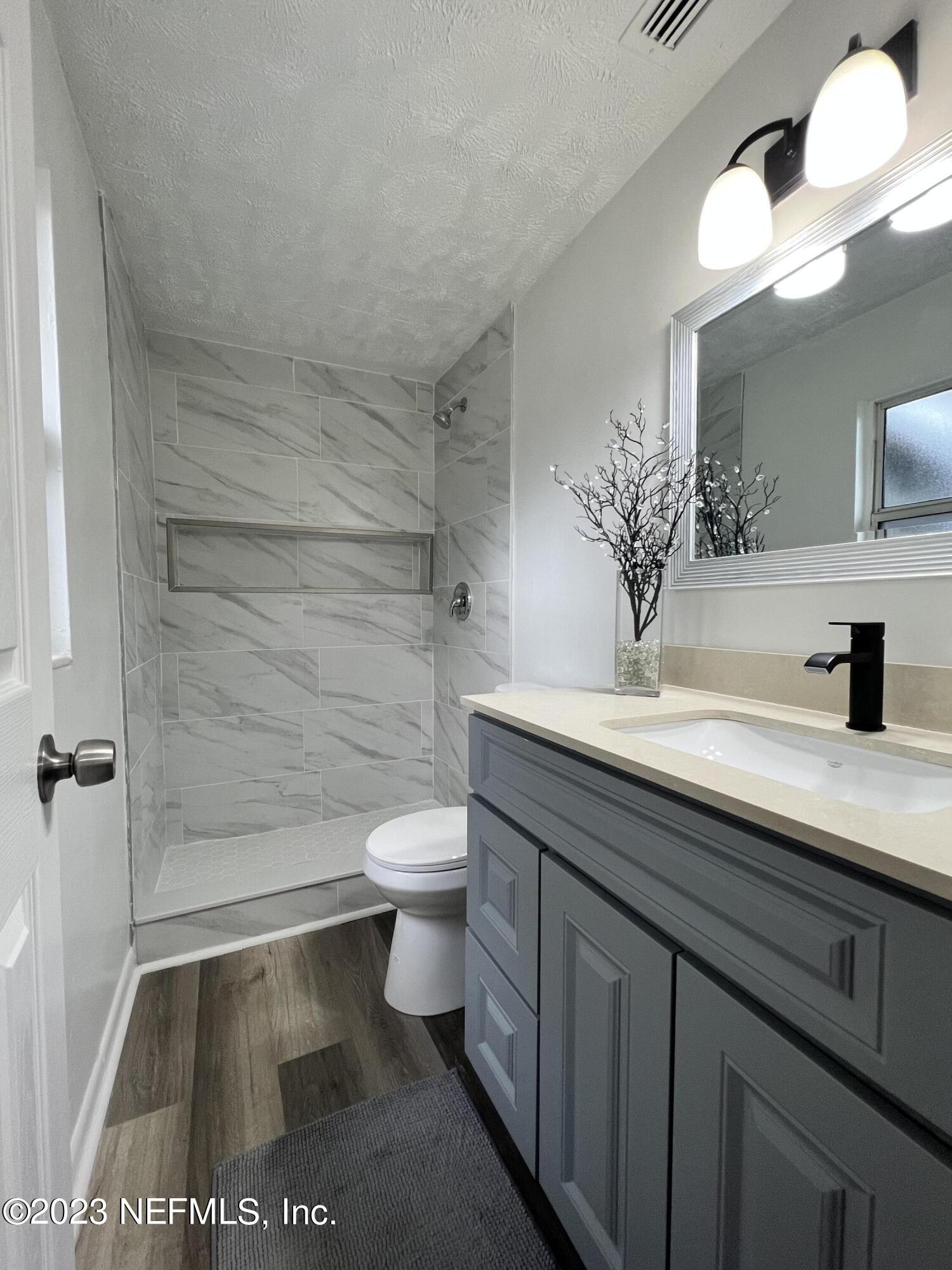 10892 Player Road Jacksonville, FL 32218 - Photo 28 of 37 a bathroom with a sink a toilet and shower
