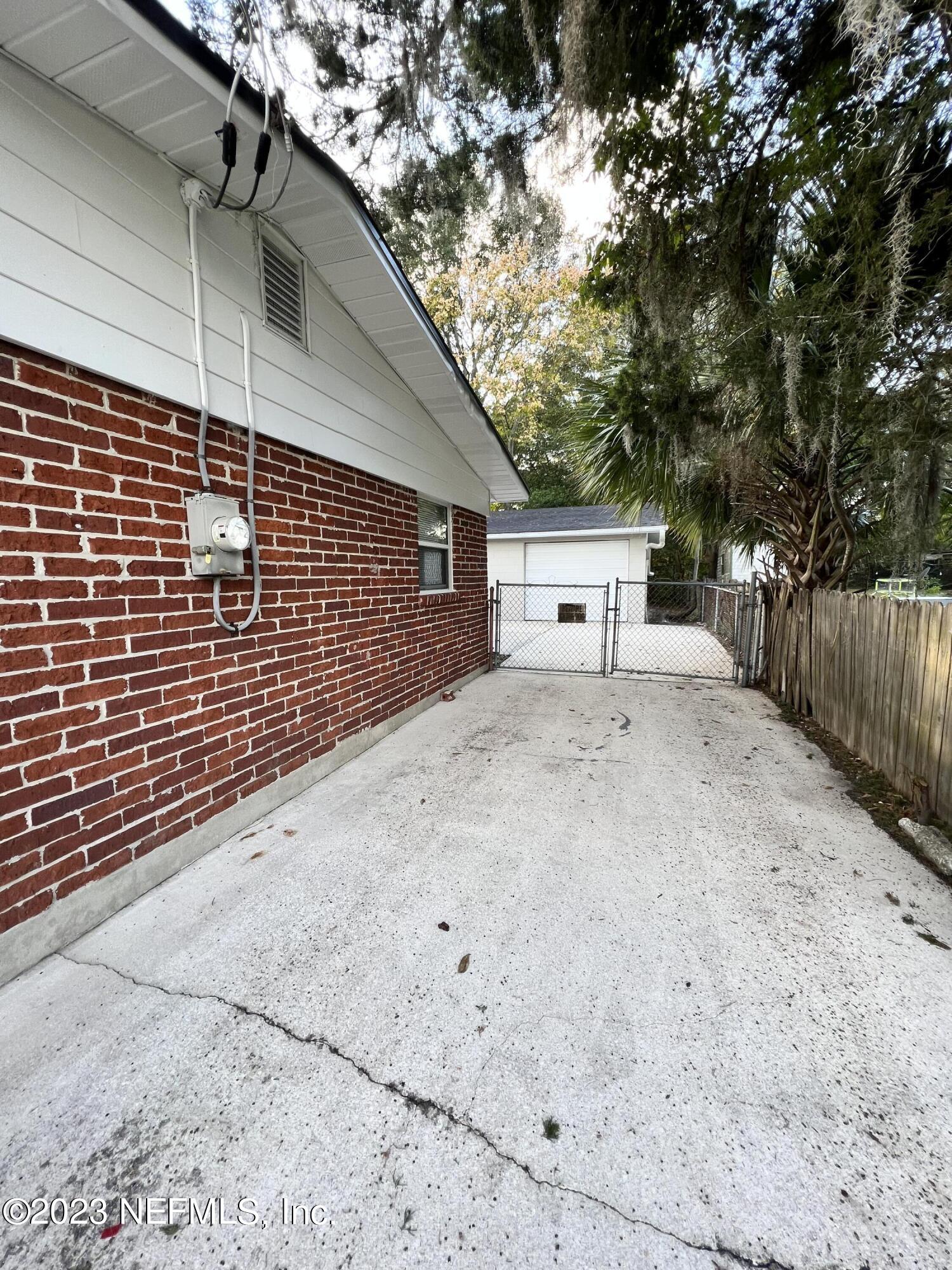 10892 Player Road Jacksonville, FL 32218 - Photo 35 of 37 a view of a house with a backyard and a tree