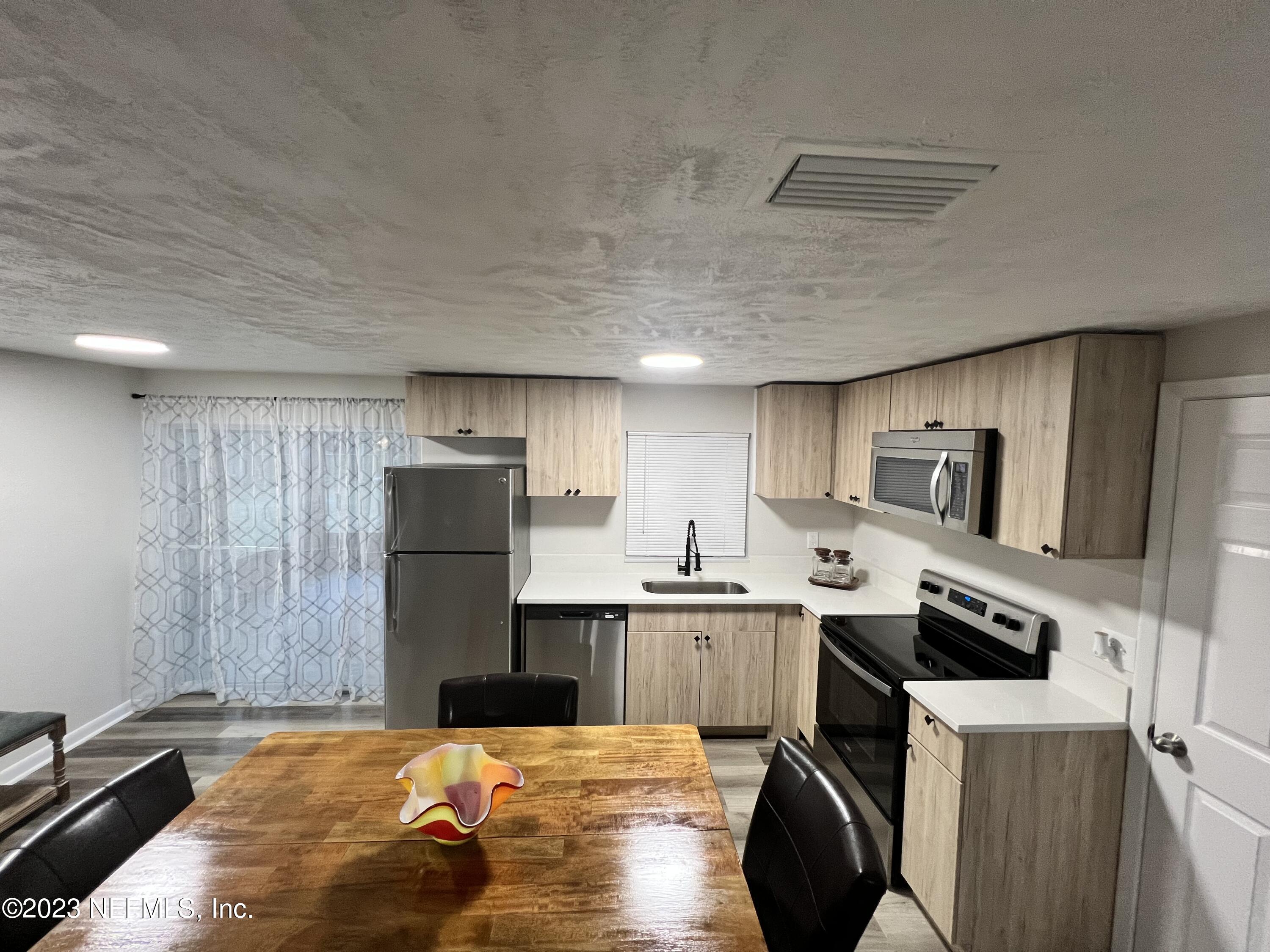 10892 Player Road Jacksonville, FL 32218 - Photo 8 of 37 a kitchen with a sink stove and refrigerator