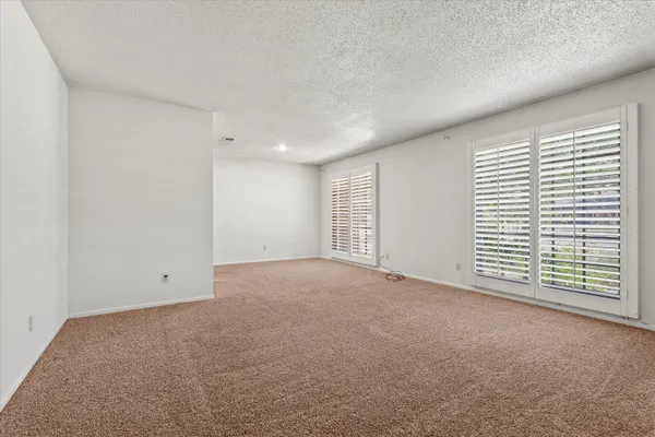 a view of a livingroom with a ceiling fan and window