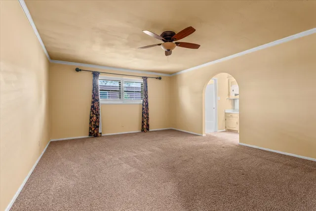 a view of a room with a ceiling fan