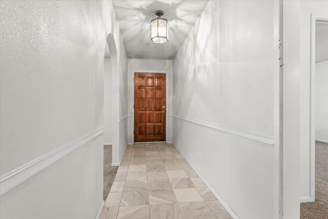 a view of empty room with fireplace and windows