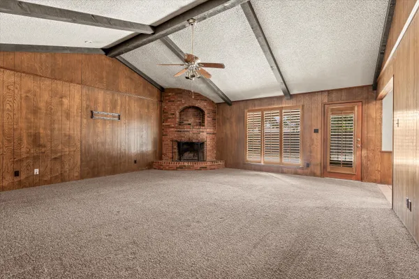 a view of empty room with fireplace