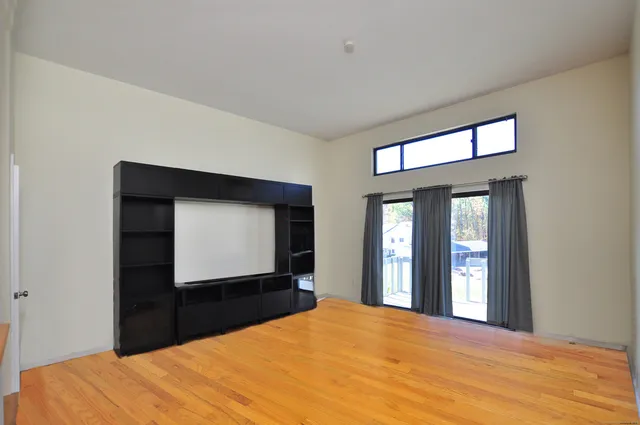 a bedroom with a bed and a large window