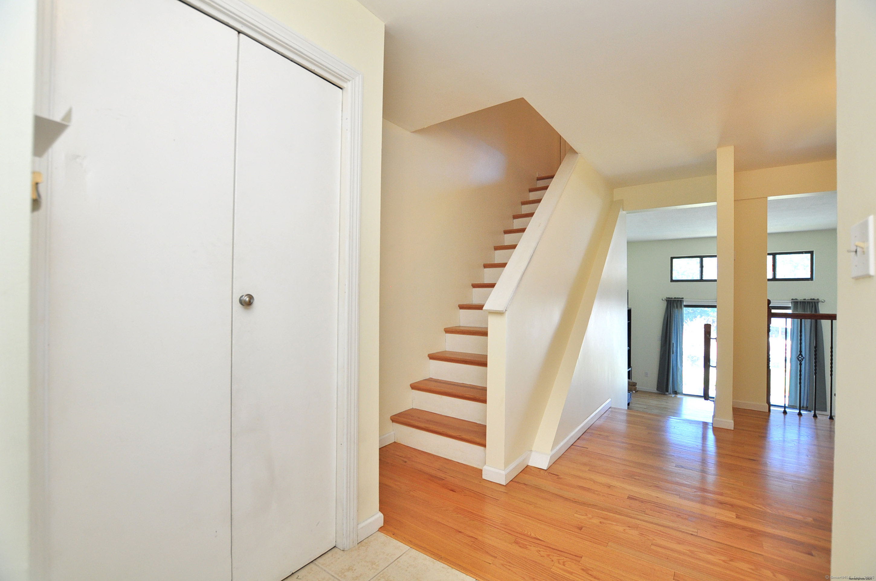 305 Timber Lane, Unit 305 Canton, CT 06019 - Photo 19 of 39 a view of a hallway with wooden floor and entryway