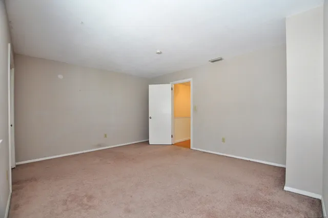 a view of an empty room with a closet