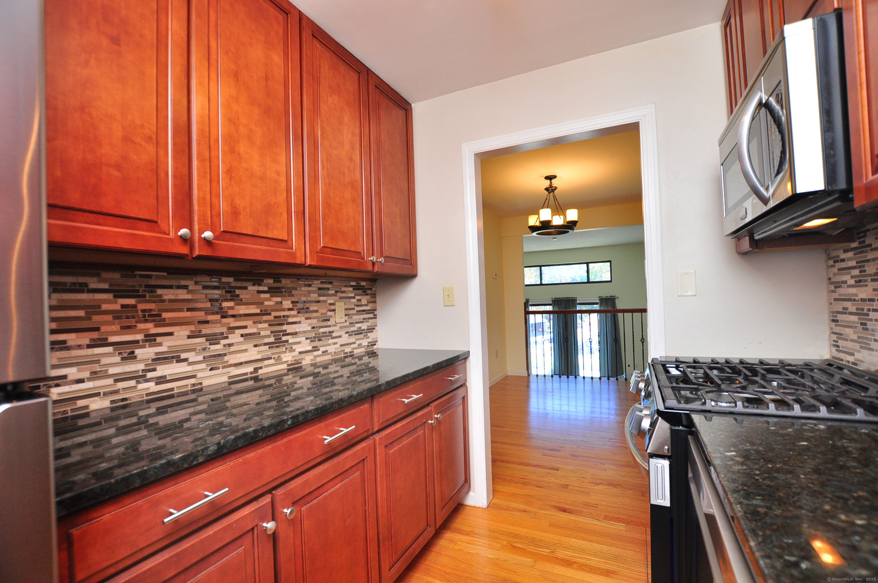 305 Timber Lane, Unit 305 Canton, CT 06019 - Photo 5 of 39 a kitchen with stainless steel appliances granite countertop a sink stove and cabinets