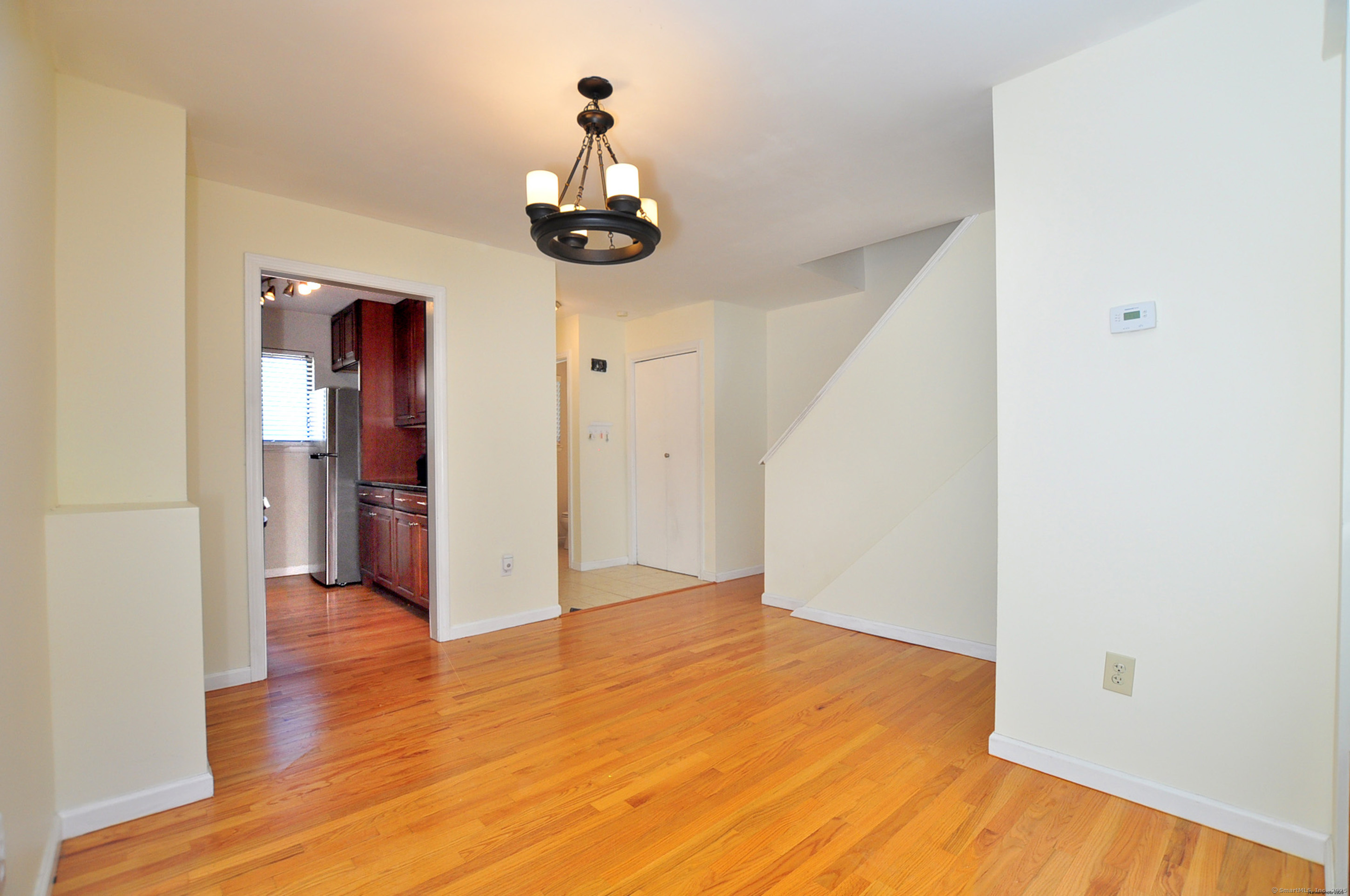 305 Timber Lane, Unit 305 Canton, CT 06019 - Photo 8 of 39 a view of empty room with wooden floor