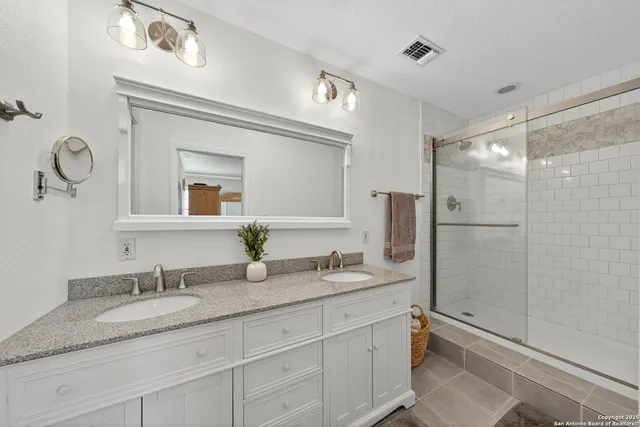 a bathroom with a granite countertop sink mirror and double