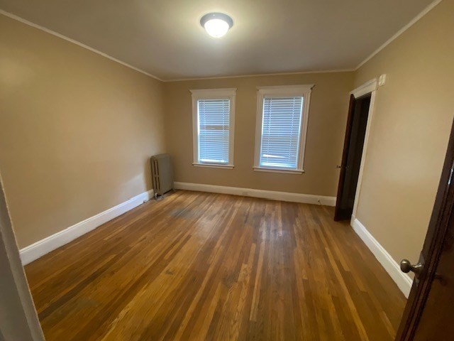 123 Glendower Road, Unit 1 Boston, MA 02131 - Photo 2 of 11 an empty room with wooden floor and windows