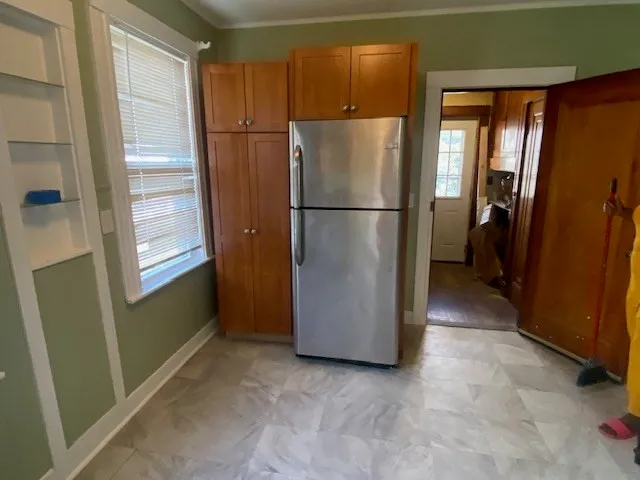 a view of a refrigerator in kitchen and furniture