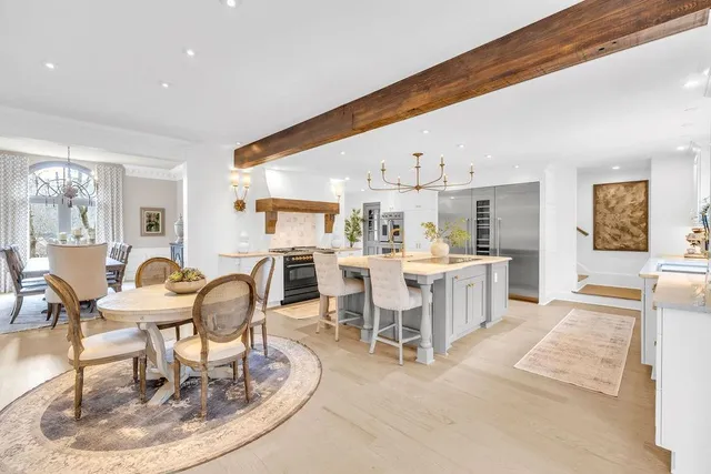 a kitchen with kitchen island a counter top space cabinets and a refrigerator