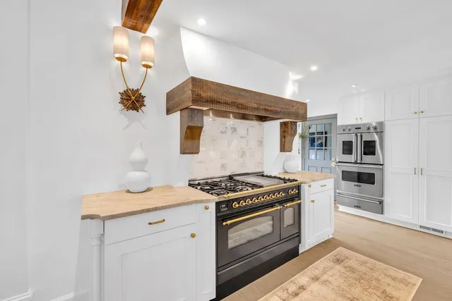 a view of a hallway with entryway and furniture