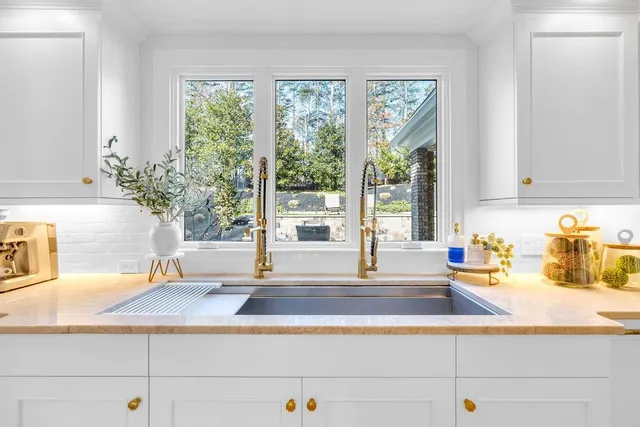 a living room with furniture a flat screen tv and a floor to ceiling window