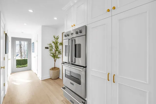 a spacious bathroom with a double vanity sink a mirror and a shower