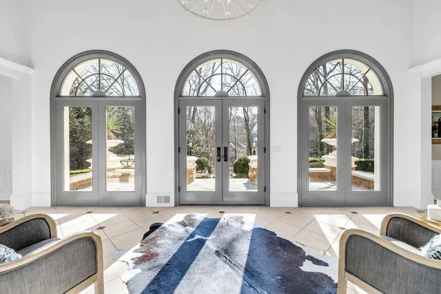 a living room with fireplace furniture and a large window