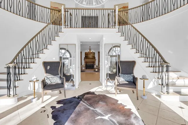 a living room with fireplace furniture and a wooden floor