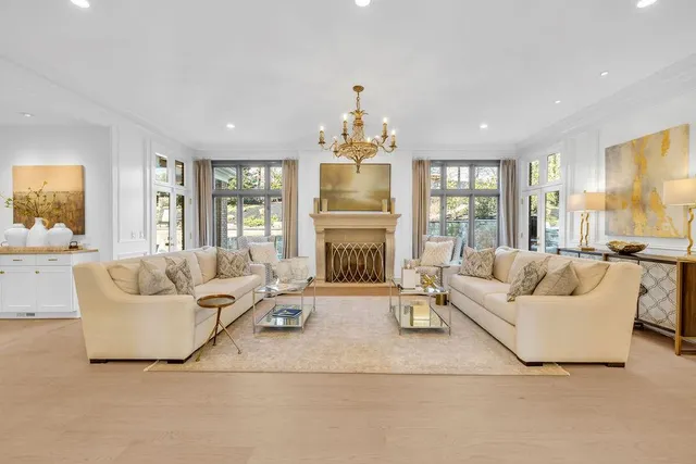 a living room with furniture a window and a flat screen tv