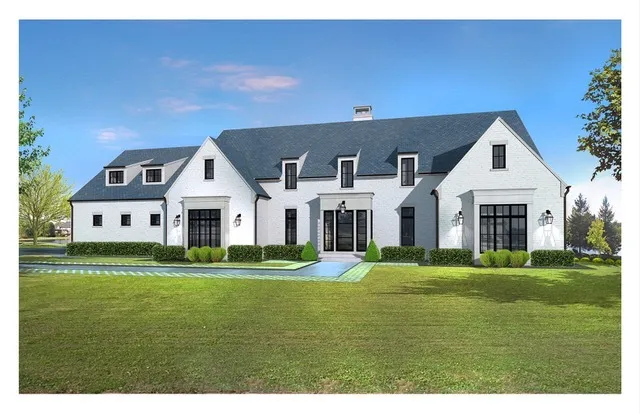 a front view of a white house with a yard and trees
