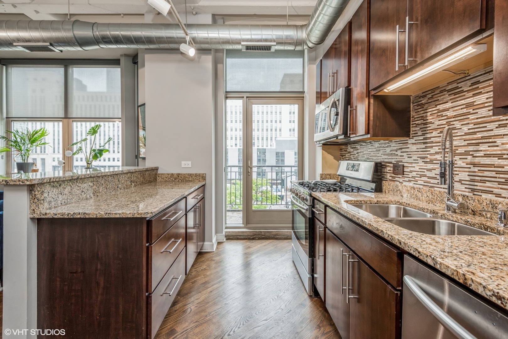 500 South Clinton Street, Unit 403 Chicago, IL 60607 - Photo 5 of 13 a kitchen with stainless steel appliances granite countertop a sink and a stove