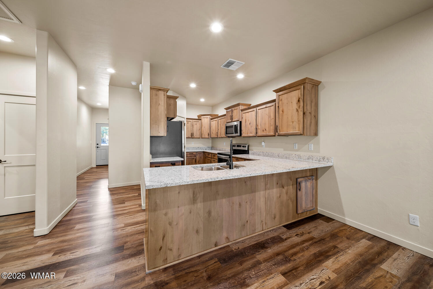 5859 Apollo Way Lakeside, AZ 85929 - Photo 11 of 35 a large kitchen with stainless steel appliances a large counter top a stove and a refrigerator