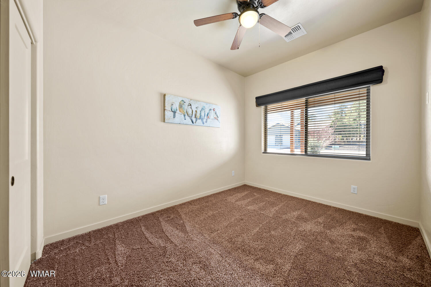 5859 Apollo Way Lakeside, AZ 85929 - Photo 21 of 35 an empty room with a window and a ceiling fan