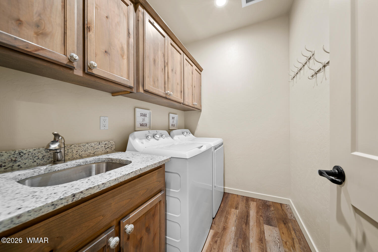 5859 Apollo Way Lakeside, AZ 85929 - Photo 23 of 35 a utility room with a sink a washer and dryer