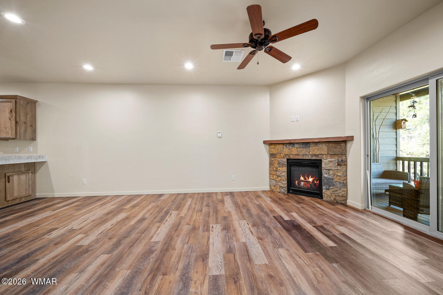 5859 Apollo Way Lakeside, AZ 85929 - Photo 5 of 35 a view of empty room with wooden floor fireplace and a window