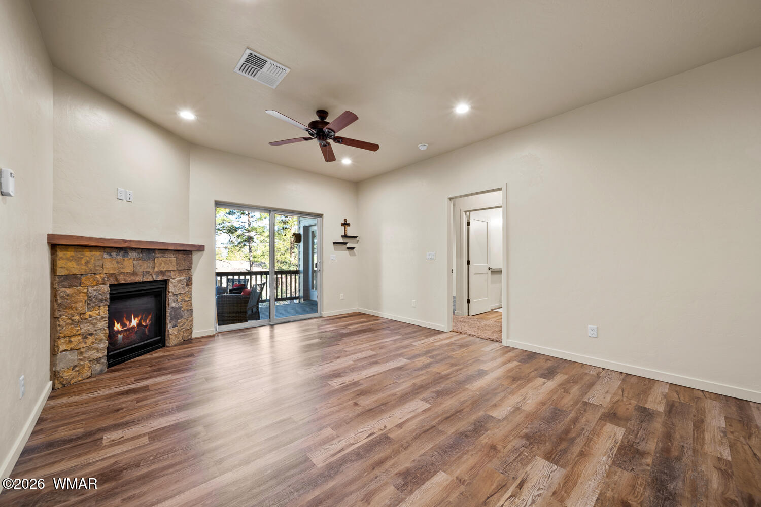 5859 Apollo Way Lakeside, AZ 85929 - Photo 6 of 35 a view of an empty room with a fireplace and a window
