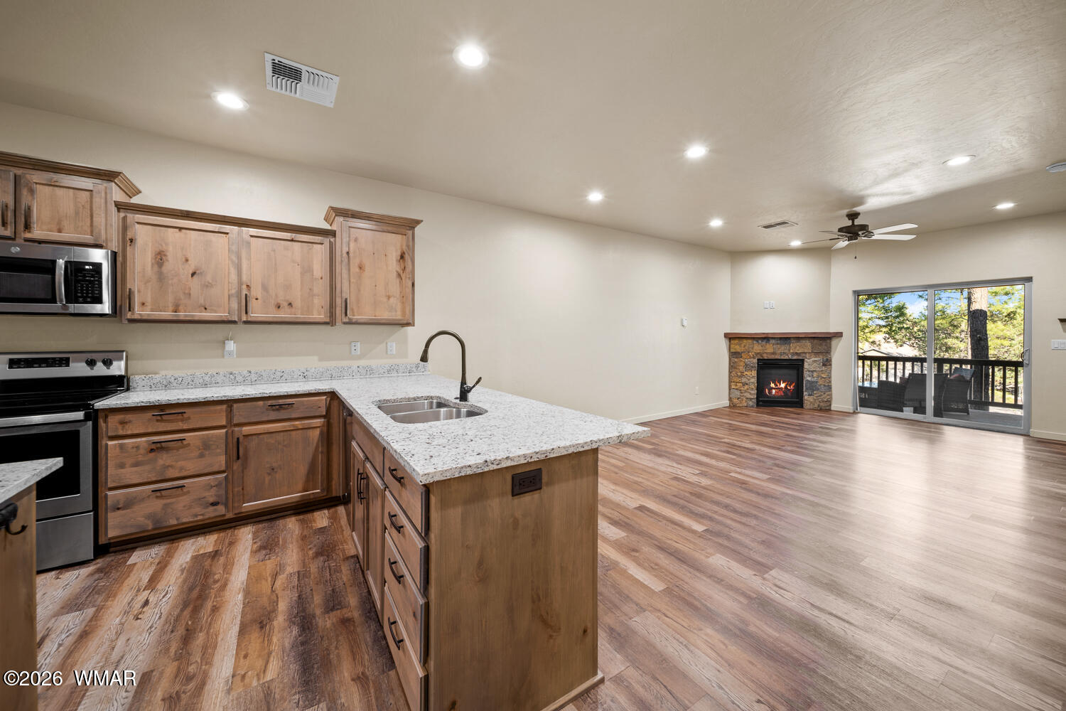 5859 Apollo Way Lakeside, AZ 85929 - Photo 7 of 35 a kitchen with a sink a microwave and cabinets