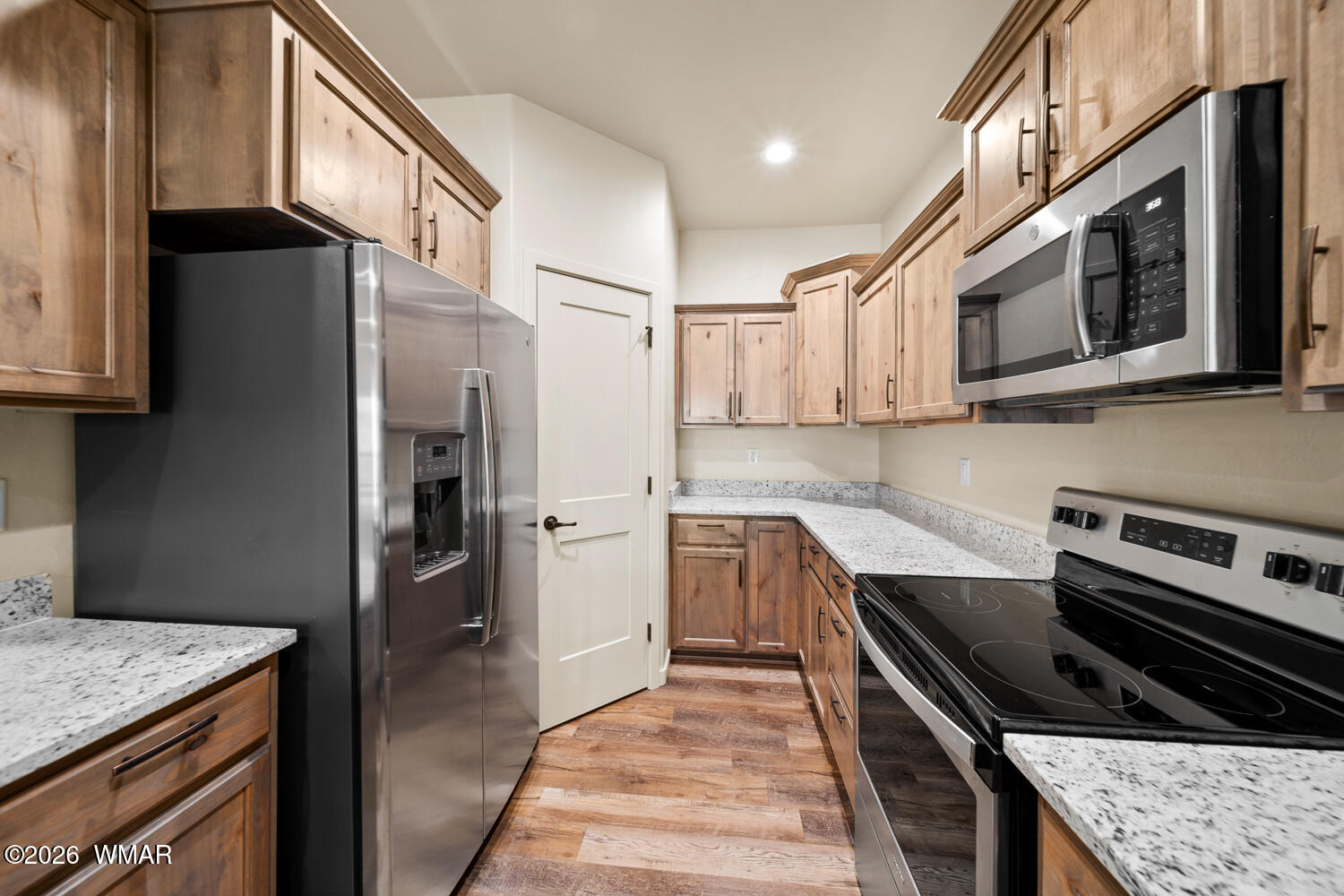 5859 Apollo Way Lakeside, AZ 85929 - Photo 9 of 35 a kitchen with stainless steel appliances granite countertop a stove a refrigerator and a microwave