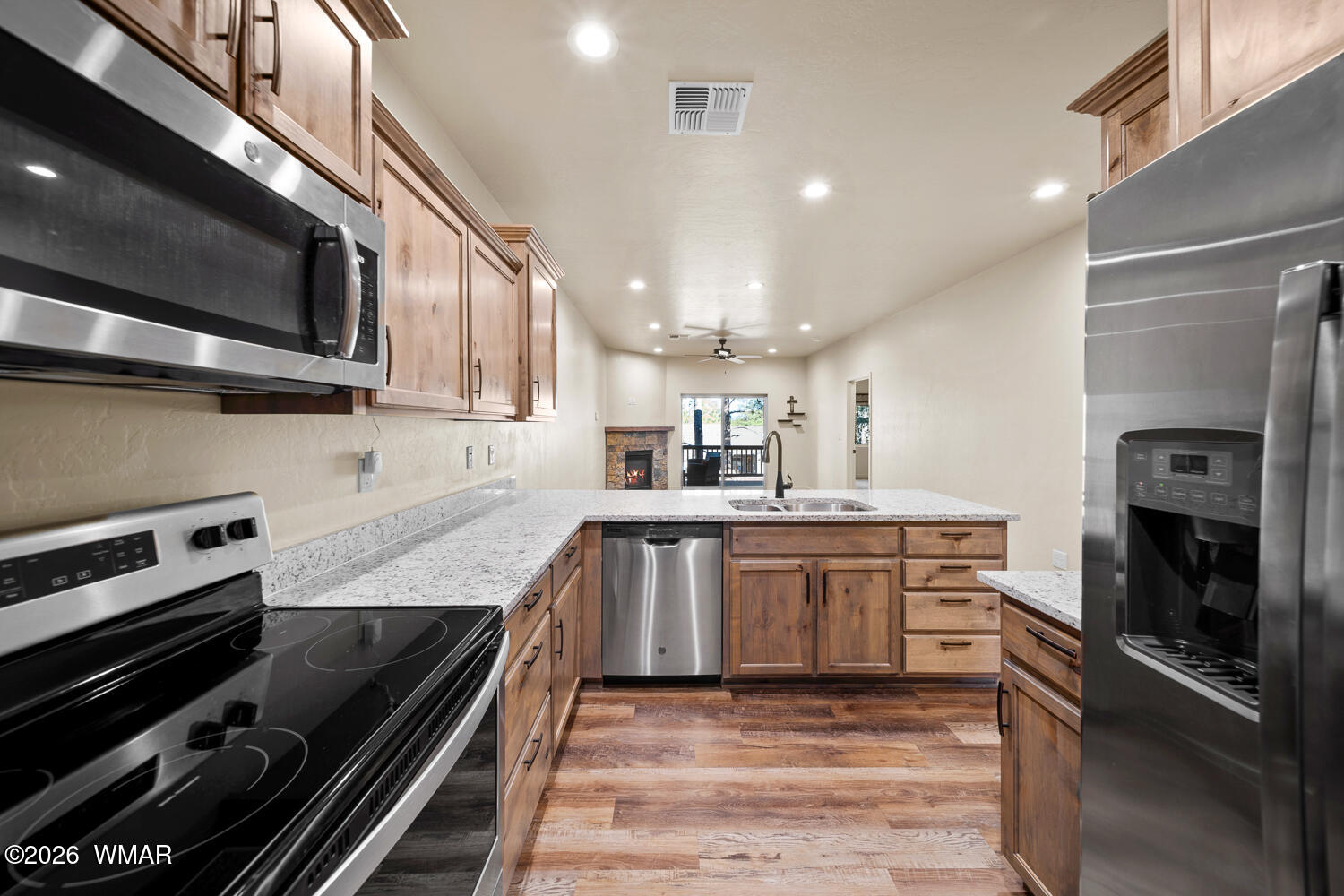 5859 Apollo Way Lakeside, AZ 85929 - Photo 10 of 35 a kitchen with stainless steel appliances granite countertop a stove and a microwave