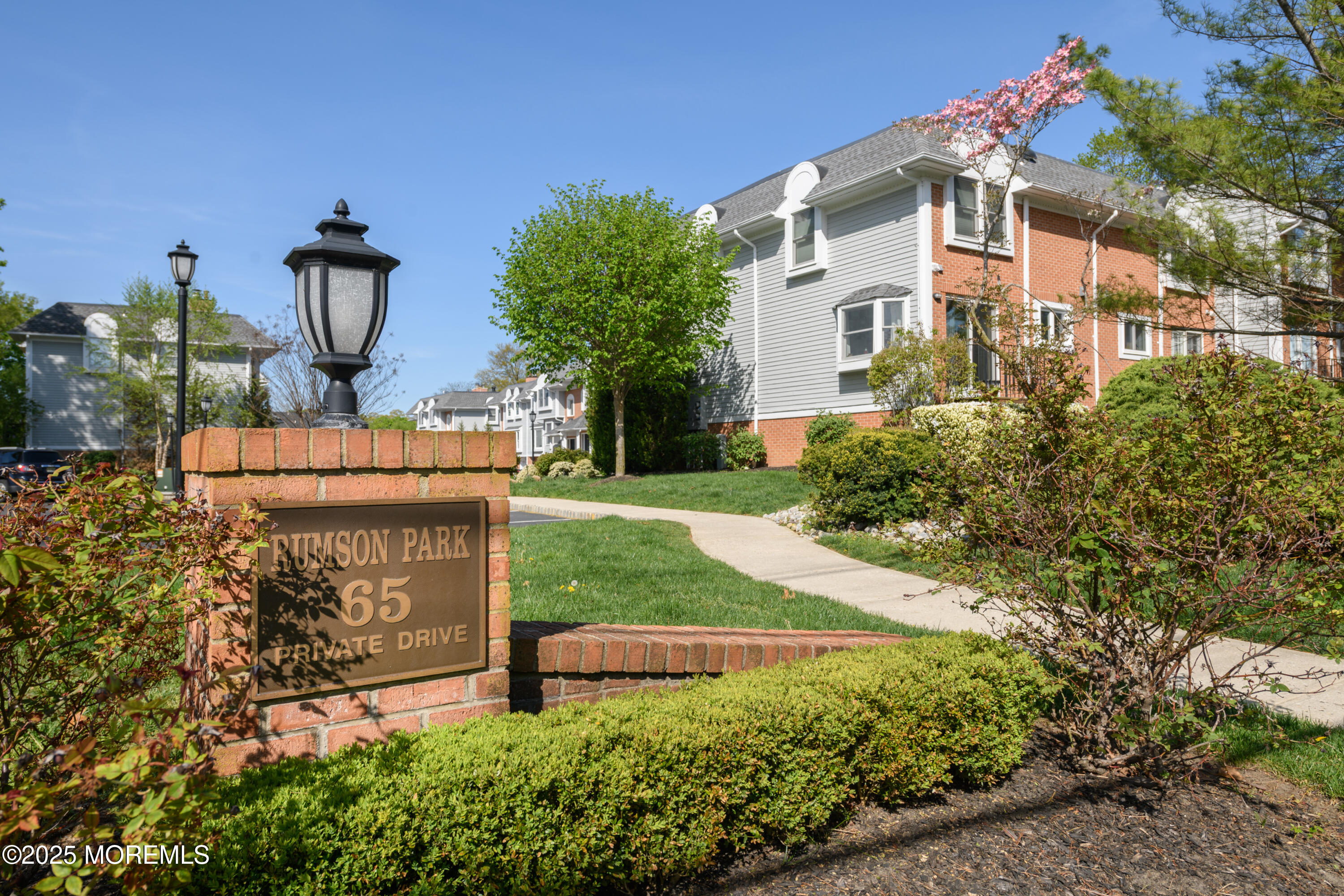65 East River Road, Unit 14 Rumson, NJ 07760 - Photo 1 of 22 a front view of a house with garden