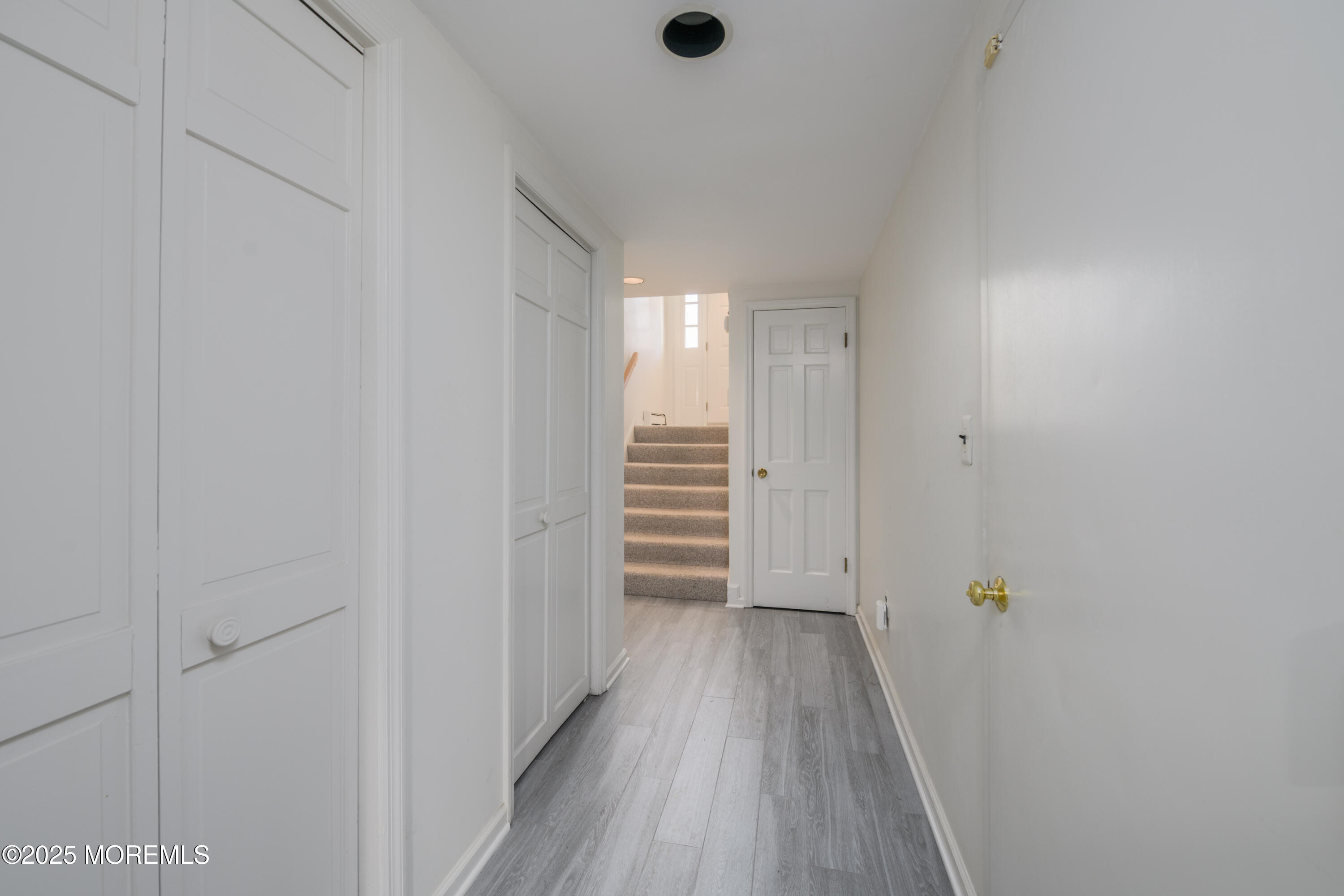 65 East River Road, Unit 14 Rumson, NJ 07760 - Photo 12 of 22 a view of a hallway with wooden floor and closet