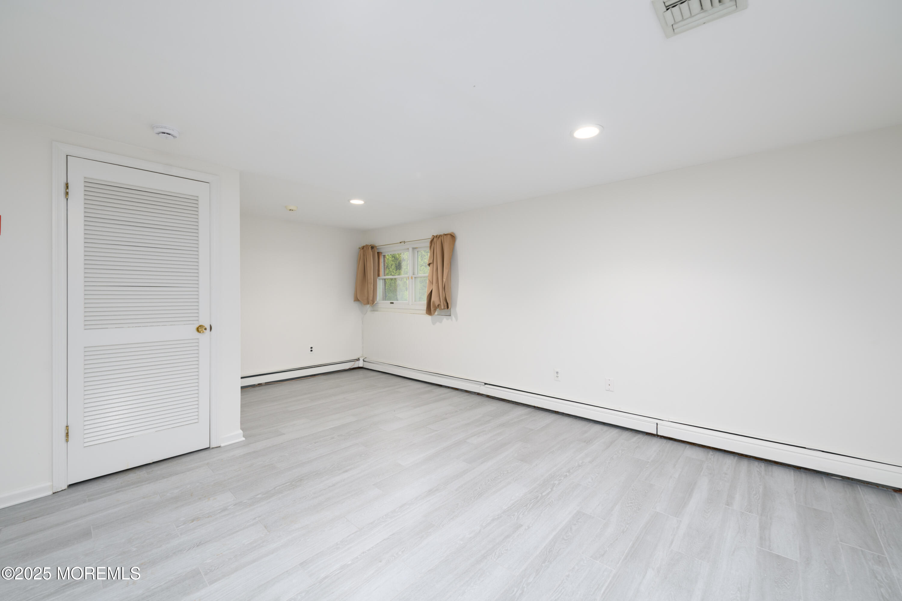 65 East River Road, Unit 14 Rumson, NJ 07760 - Photo 13 of 22 an empty room with wooden floor and windows