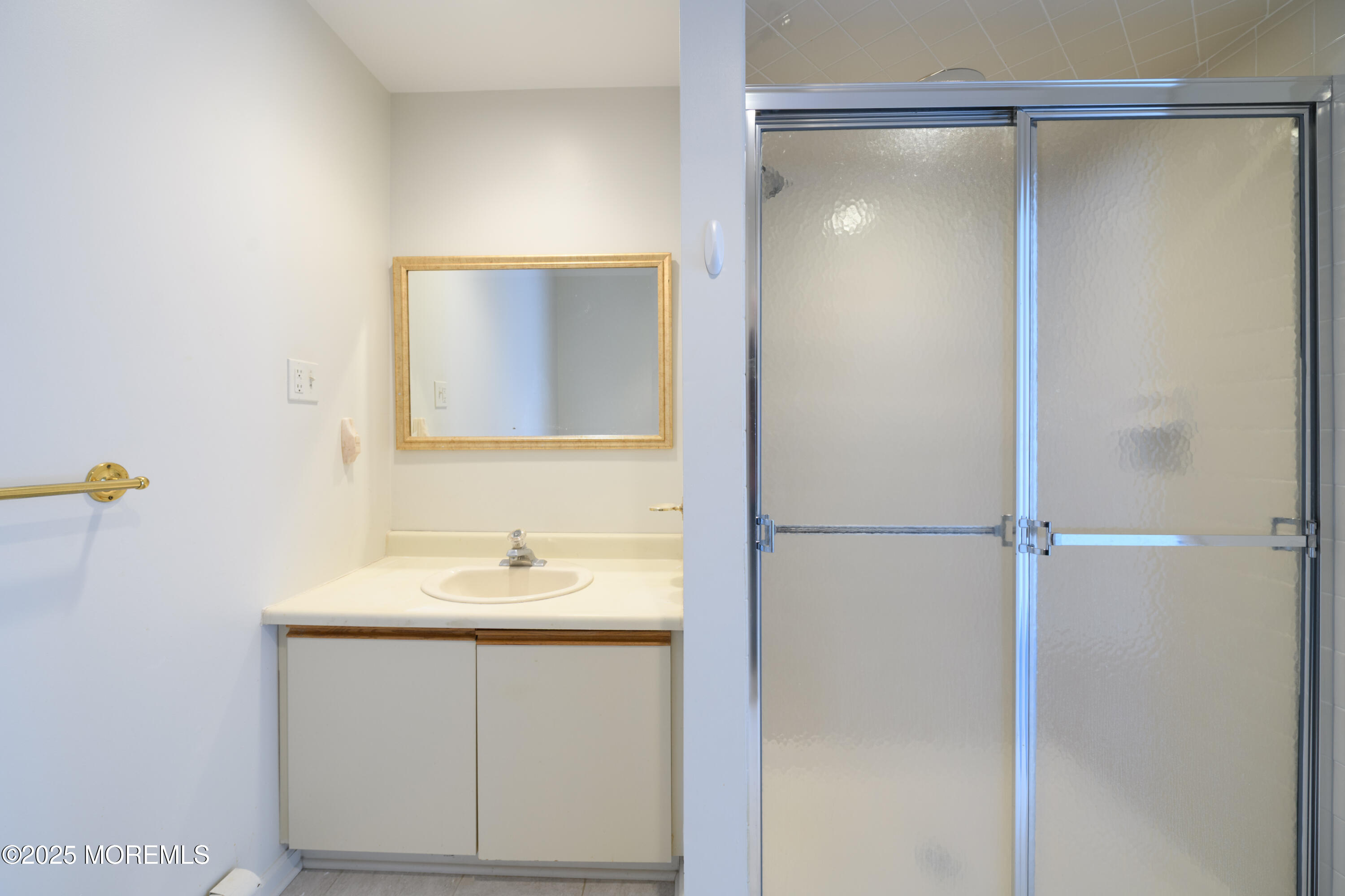 65 East River Road, Unit 14 Rumson, NJ 07760 - Photo 17 of 22 a bathroom with a sink and a mirror