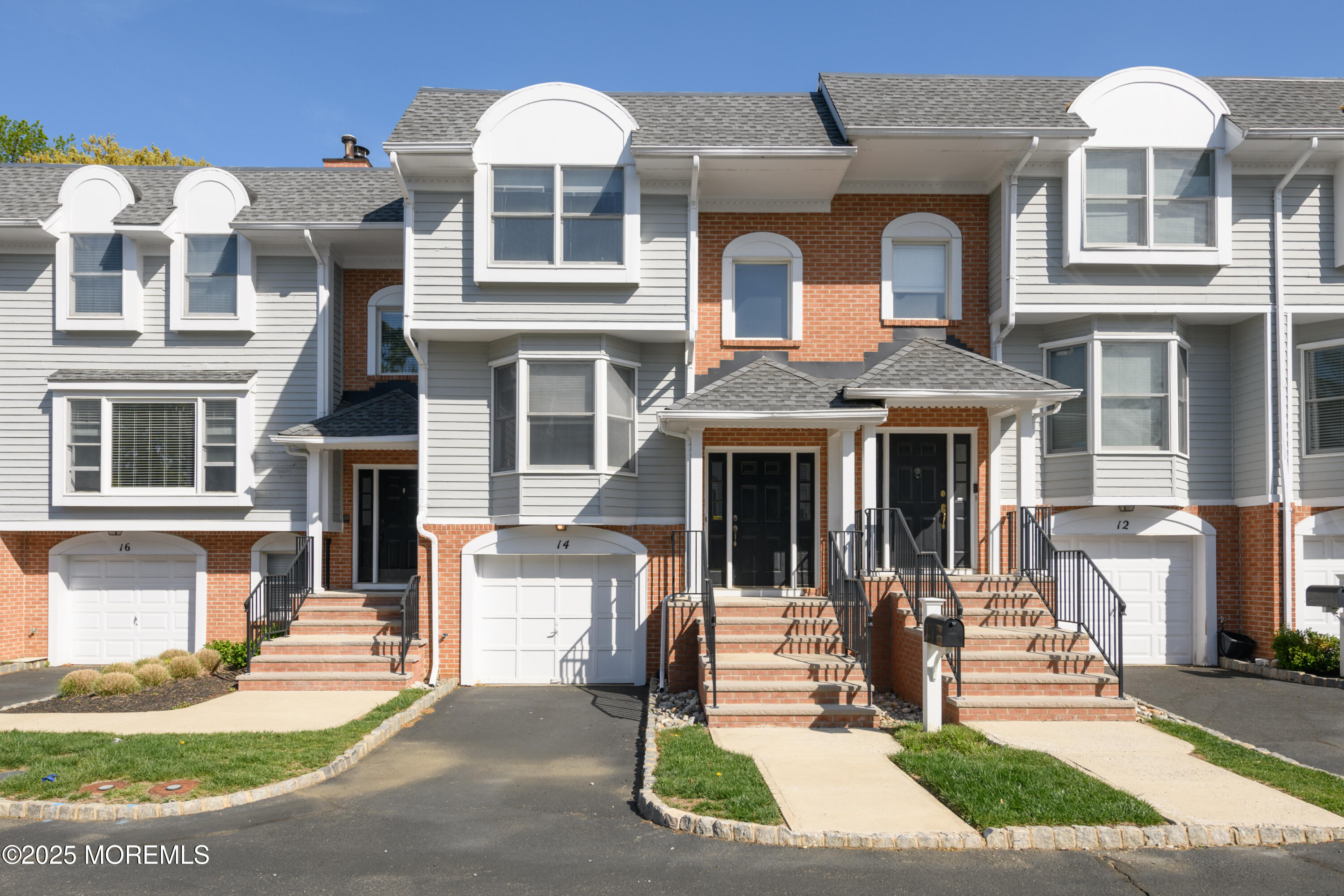 65 East River Road, Unit 14 Rumson, NJ 07760 - Photo 3 of 22 a front view of a house with a garden