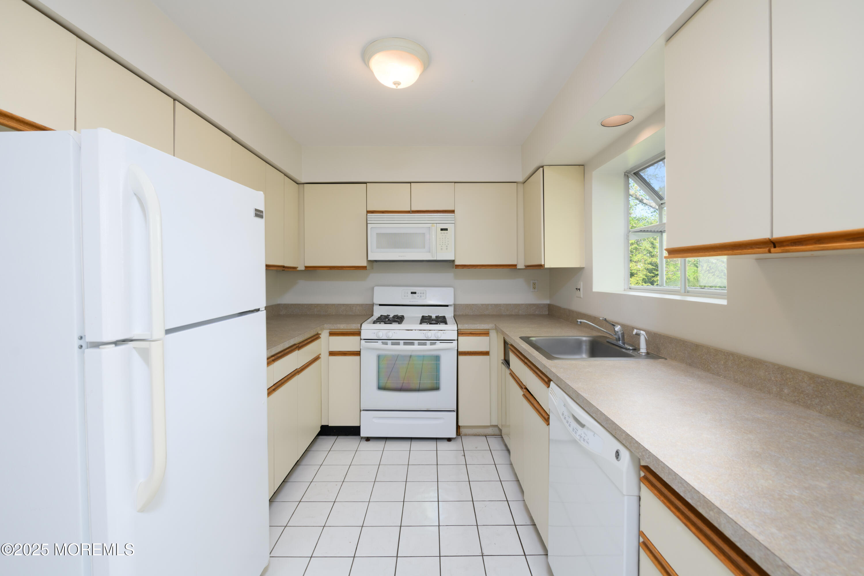 65 East River Road, Unit 14 Rumson, NJ 07760 - Photo 10 of 22 a kitchen with a white cabinets and white appliances