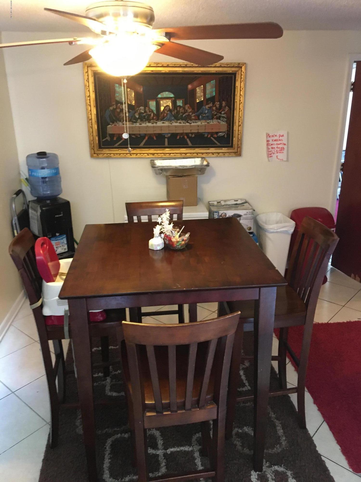 4870 Strato Road West Jacksonville, FL 32210 - Photo 4 of 14 a view of a dining room with furniture and chandelier