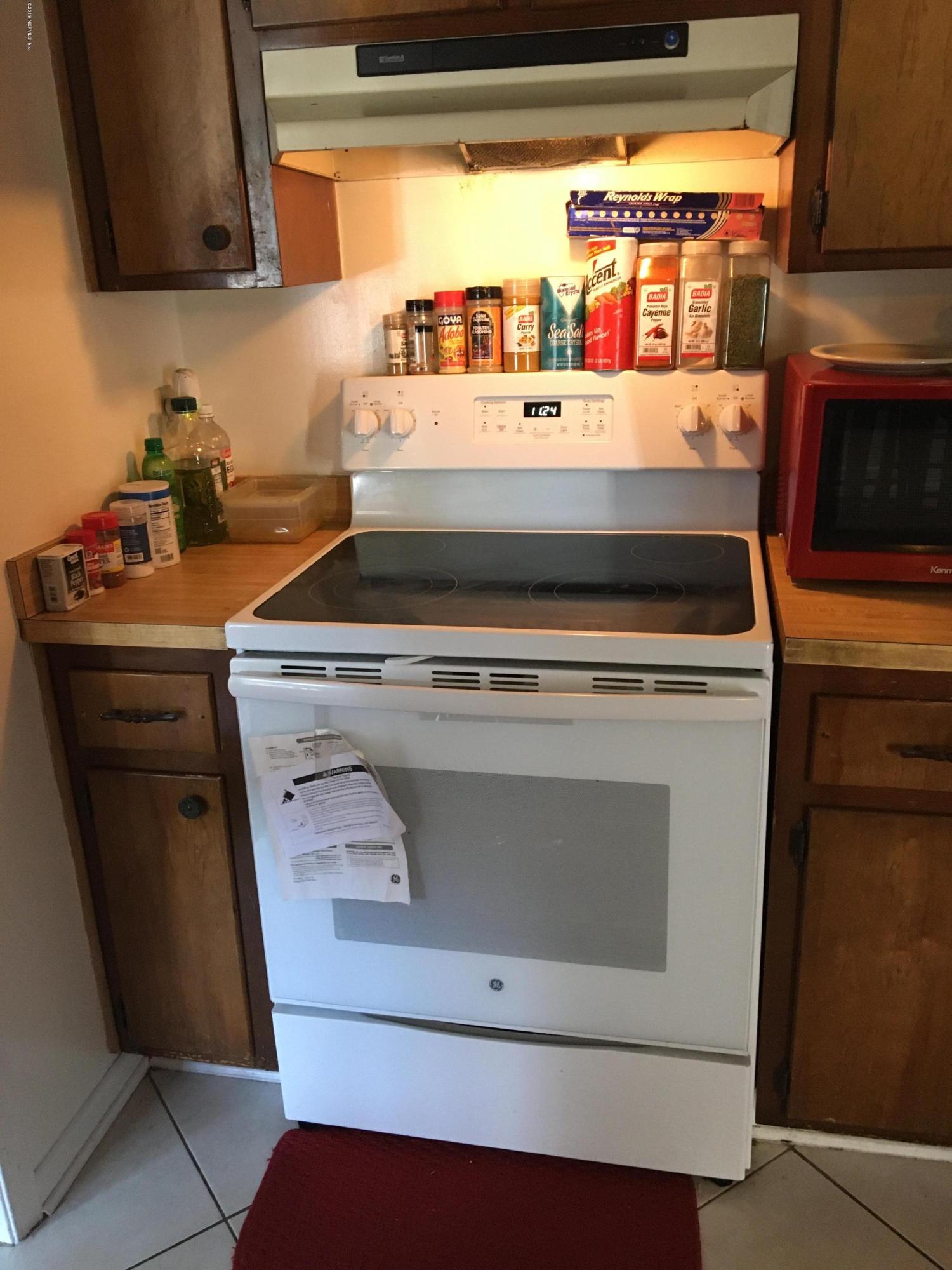 4870 Strato Road West Jacksonville, FL 32210 - Photo 6 of 14 a stove top oven sitting inside of a kitchen