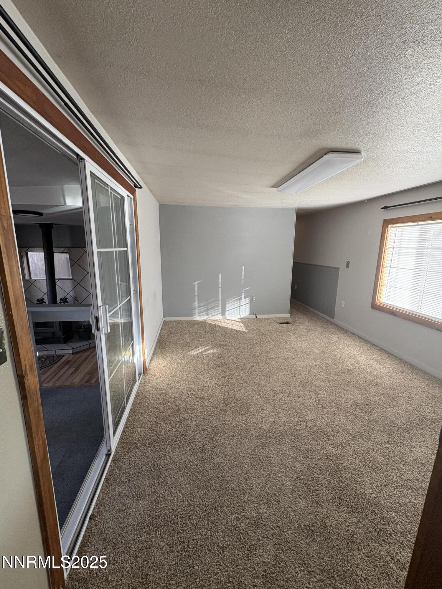 20 Miley Lane Yerington, NV 89447 - Photo 13 of 29 wooden floor in an empty room with a window