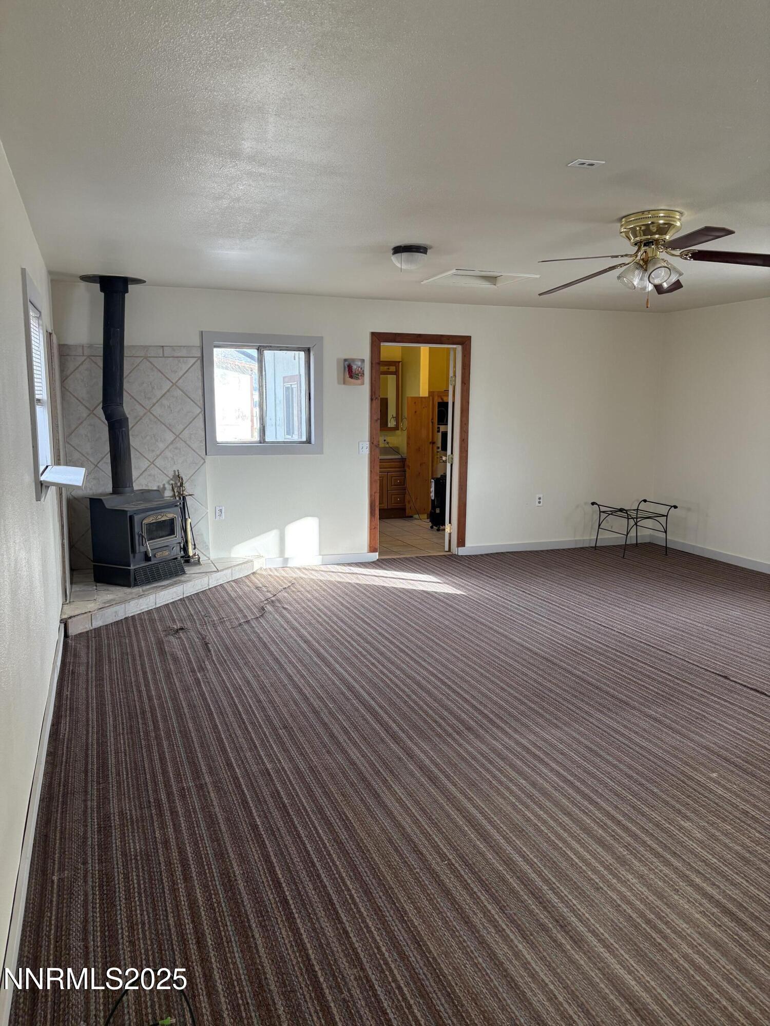 20 Miley Lane Yerington, NV 89447 - Photo 16 of 29 a view of empty room with wooden floor and fan